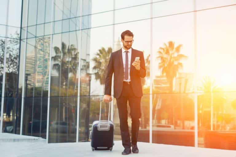 business traveler with safety app