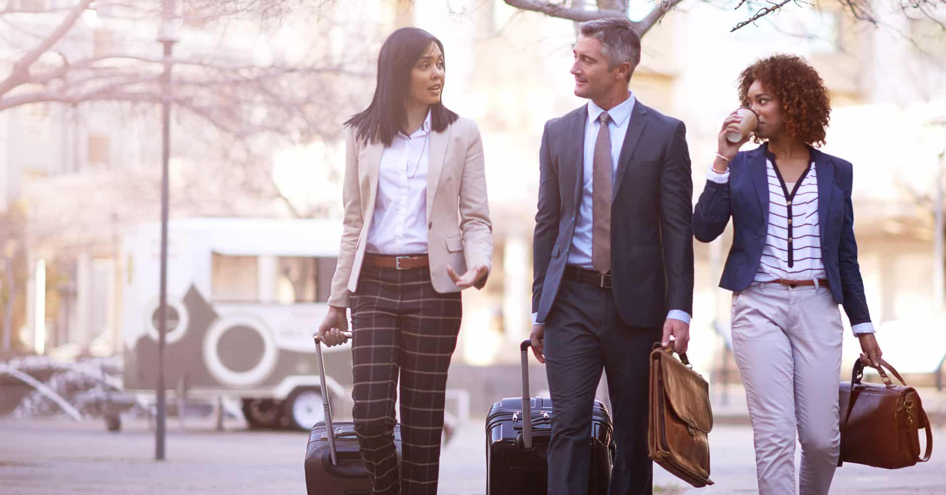 Three business travelers with luggage