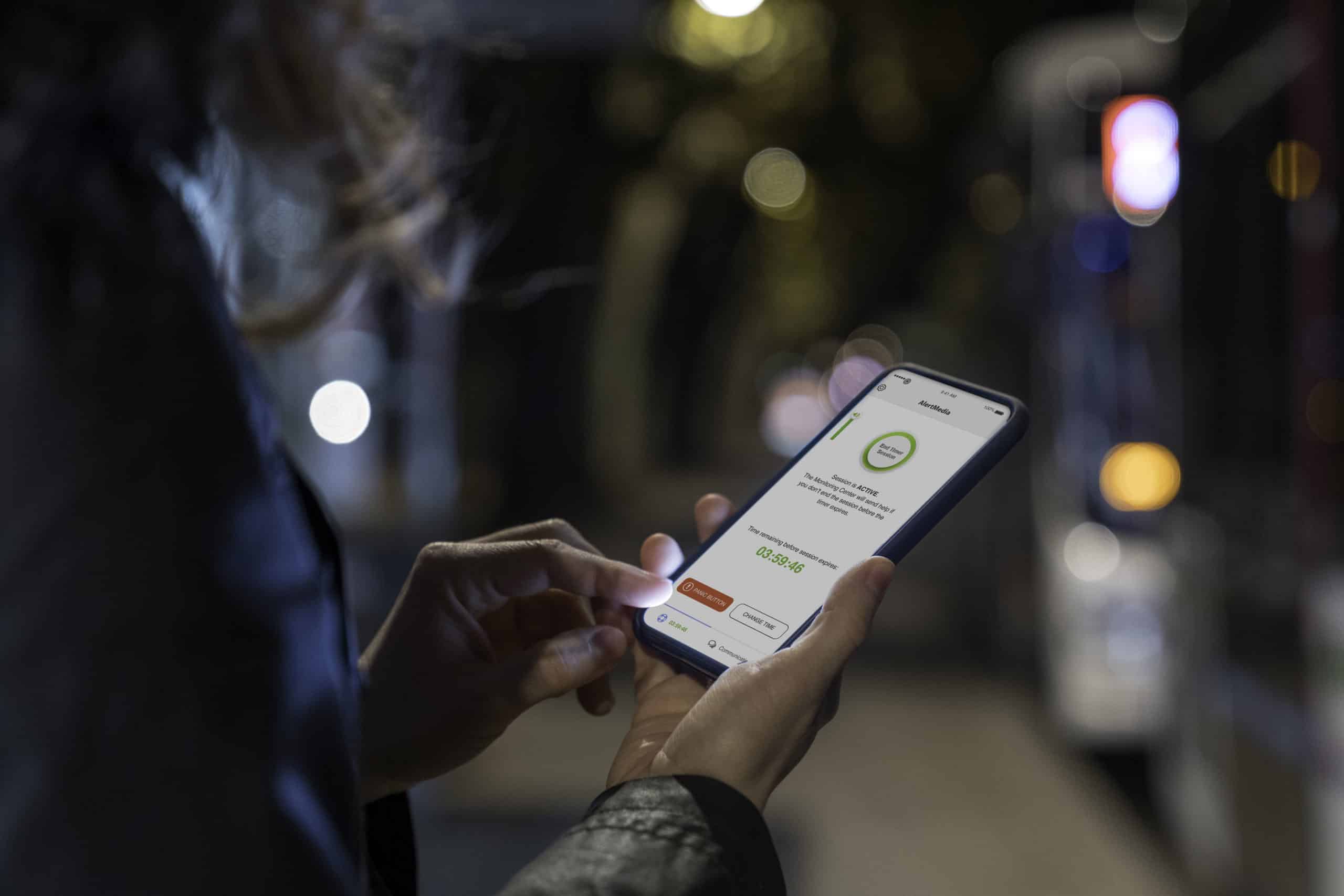 Woman looking at lit phone with navigation map photographed at night in a city