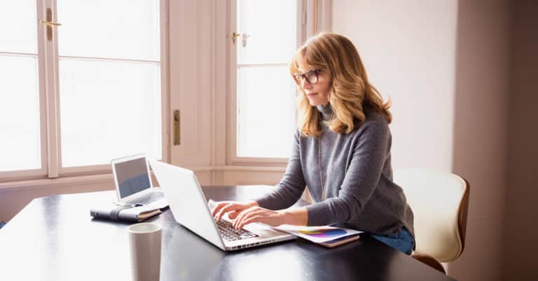 Remote employee in home office with winter scenery