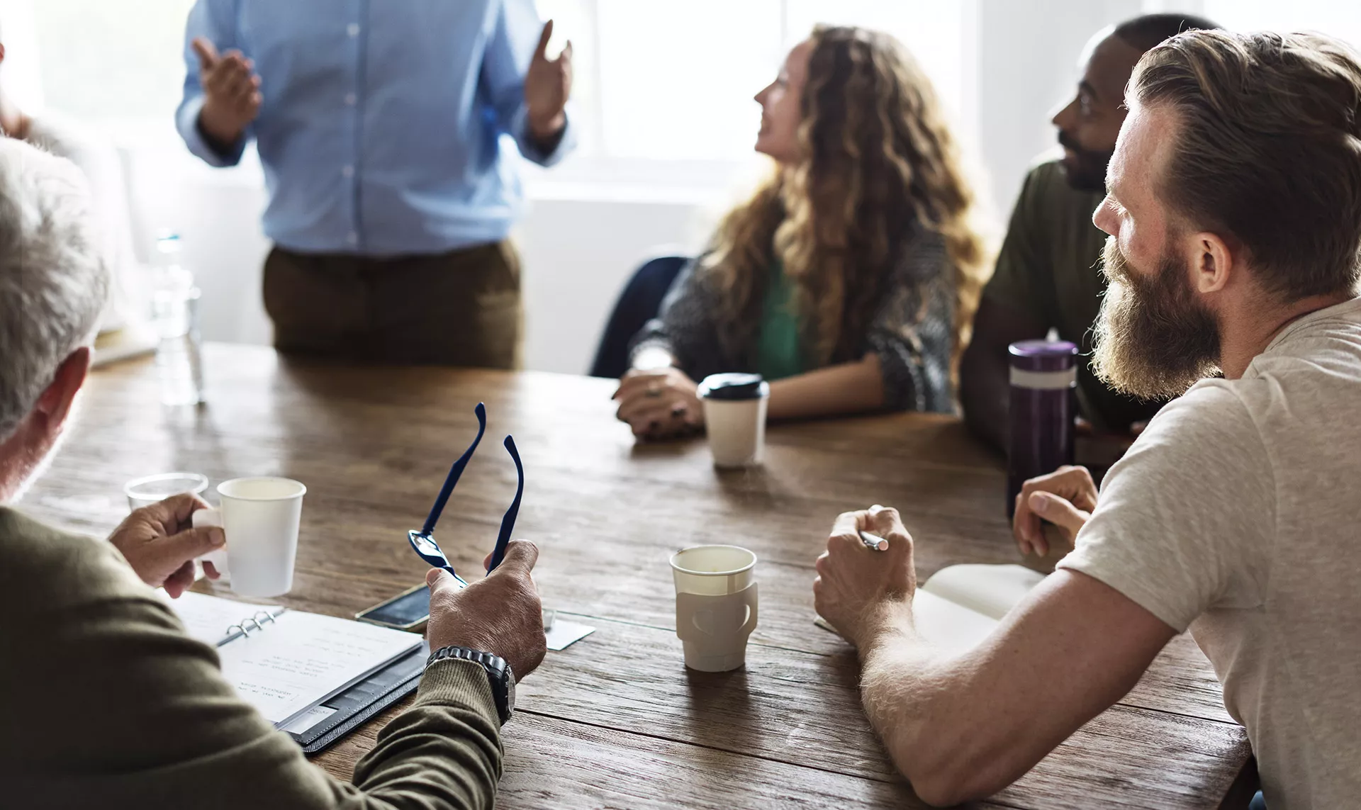 People gathered around an office table for a meeting