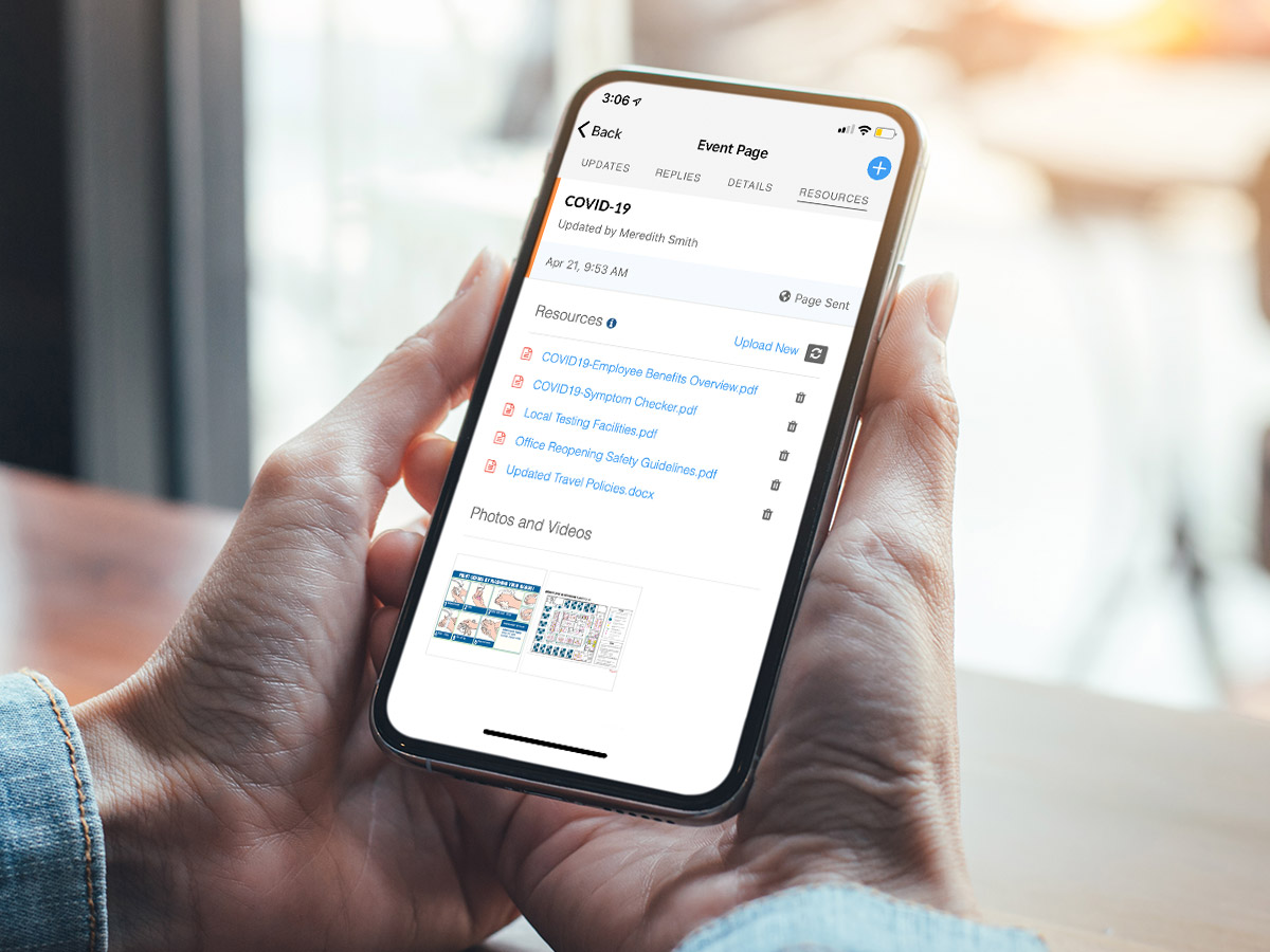 hands holding mobile device with event page about COVID-19