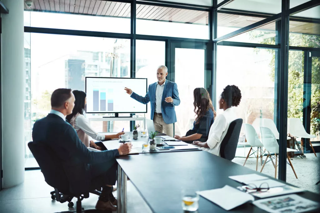 Businessman giving a presentation in a boardroom.