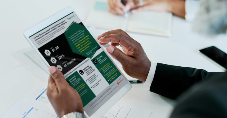 Man holding tablet showing summary of Forrester TEI Study