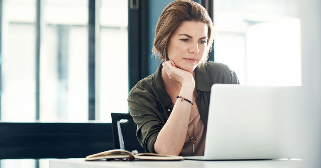 Woman working at laptop in office setting