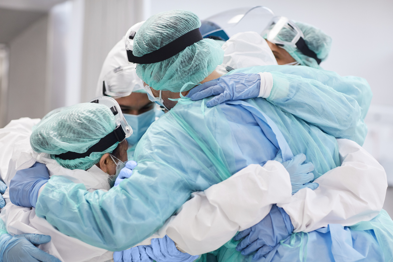 Doctors and nurses embracing each other during pandemic