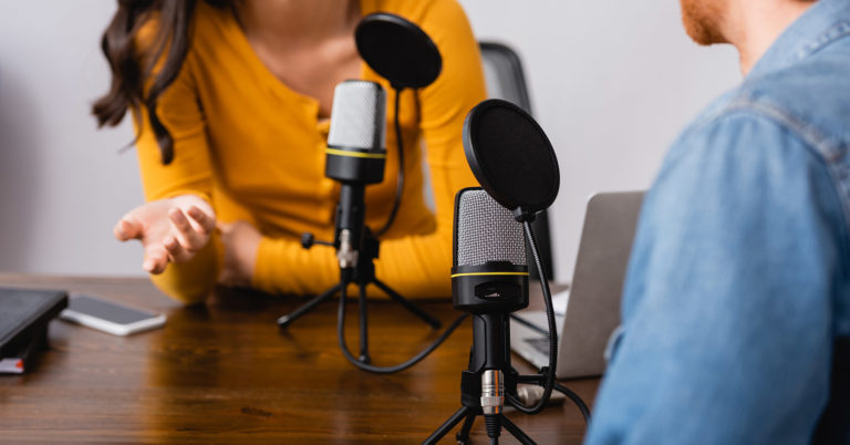 Two people in front of podcast mics giving preparedness advice