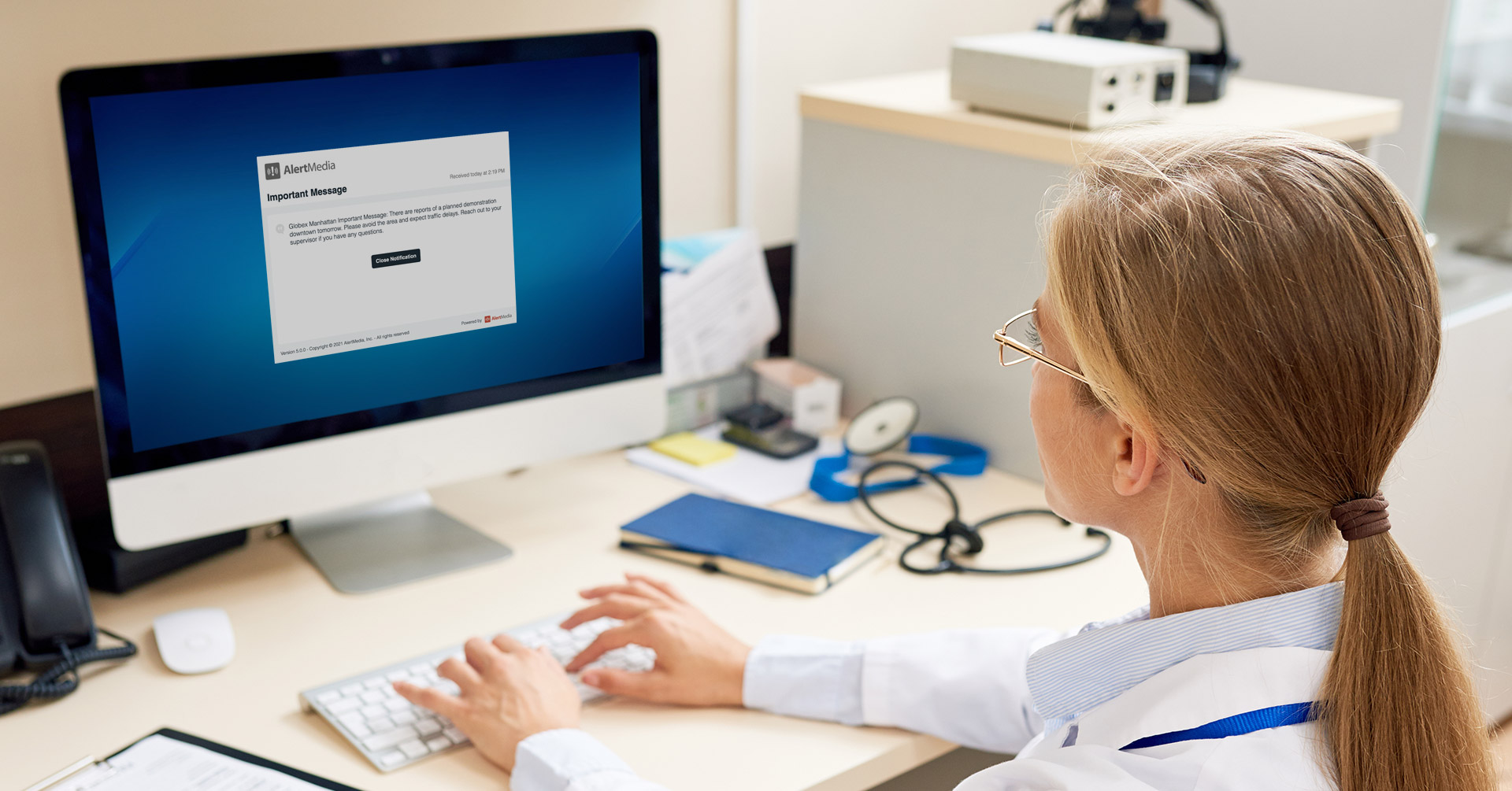 Person viewing emergency notification on desktop computer