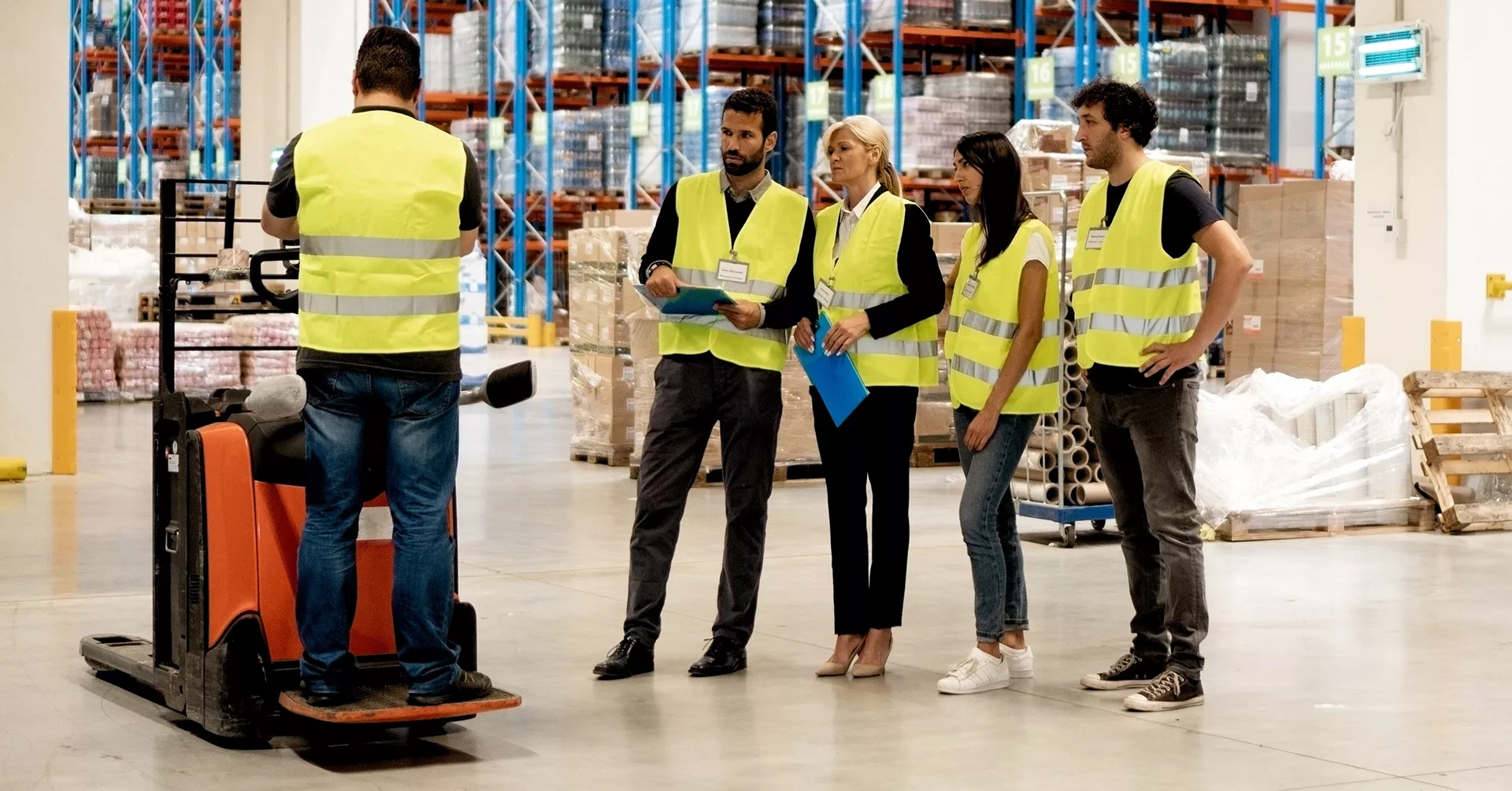 a group of warehouse workers in a safety meeting