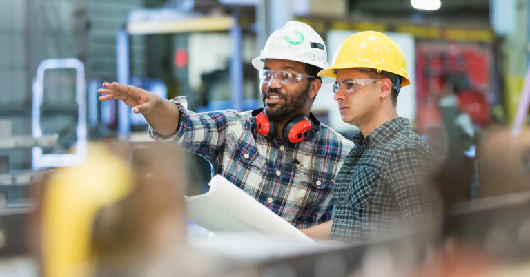 Two construction workers share safety quotes