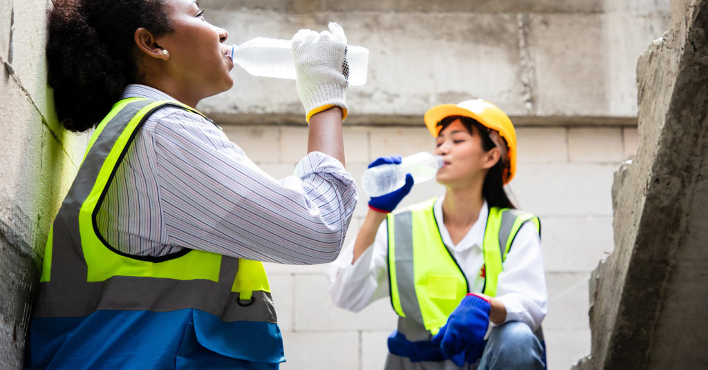 Construction workers drinking water