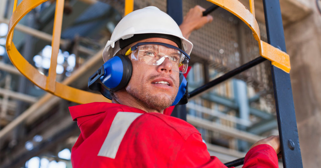 Construction worker descends ladder