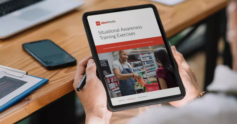 Someone holding a tablet and pen in front of a table with the resource on the tablet