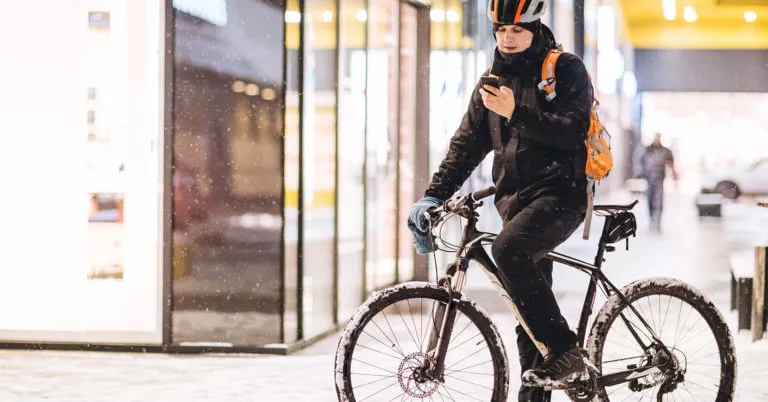 Employee bikes to work through winter weather hazards.