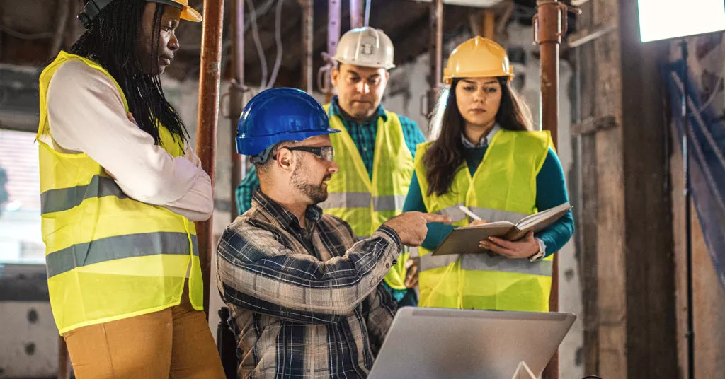 Workers discussing plans