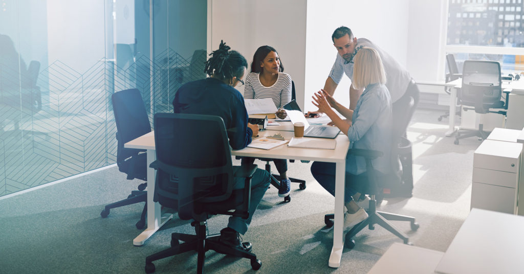 People sitting around a table building an emergency evacuation plan