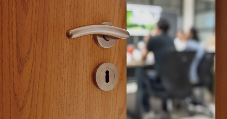 Workers in conference room behind door with lock.