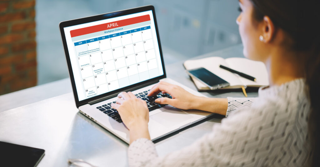 A woman works on her laptop, planning safety programs with a calendar template.