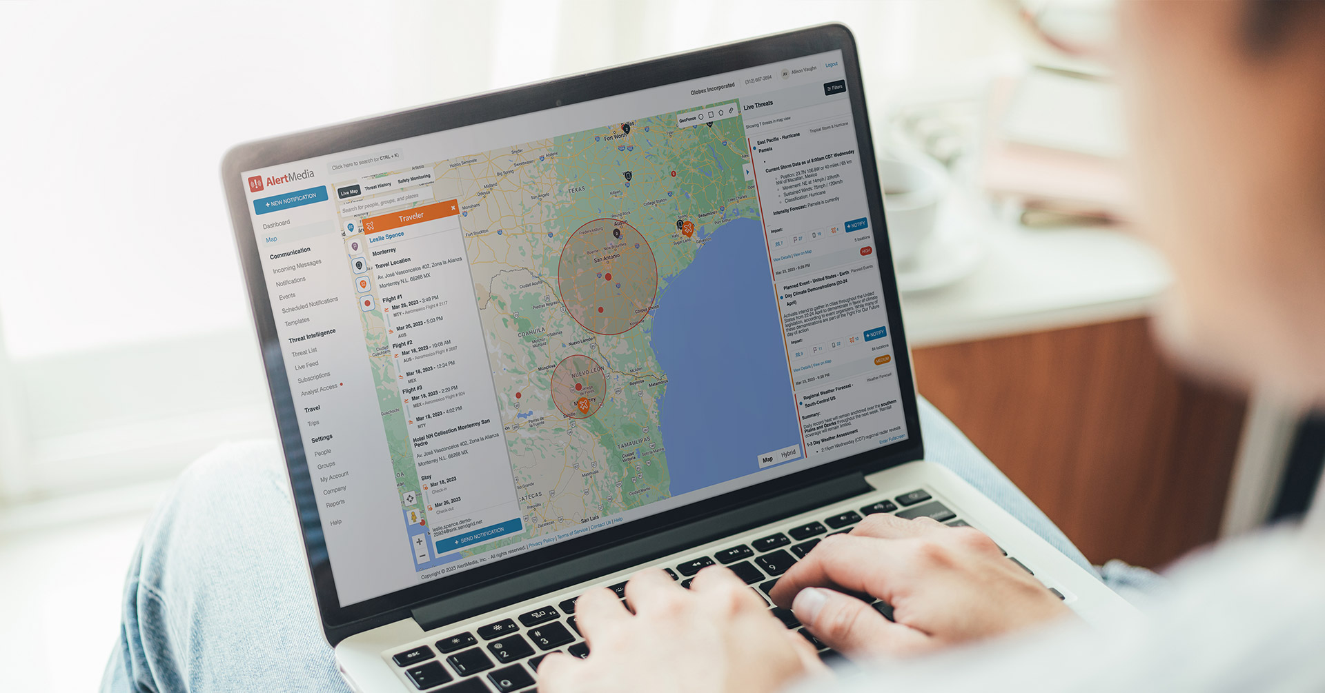 A person views threat details within a given radius on the Travel Risk Management live map on a laptop computer.