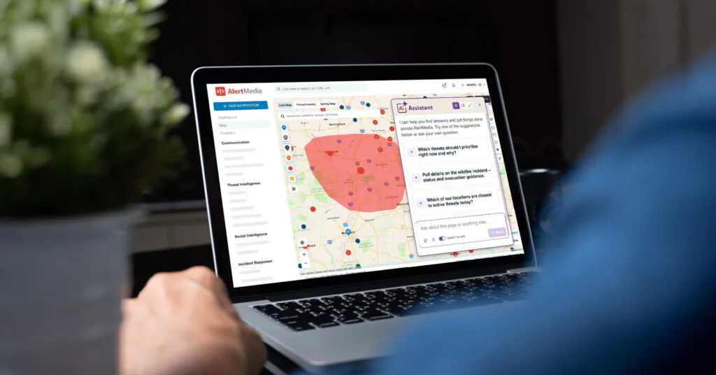 Person using AlertMedia’s AI Assistant on a laptop to assess active threats on a map.