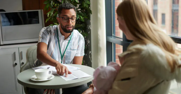 Home health worker meeting with a mother and baby during a client visit